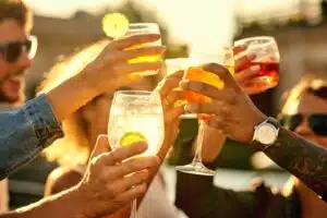 Group of people holding their drinks together