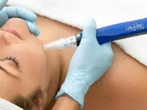 Person receiving skin treatment with handheld device