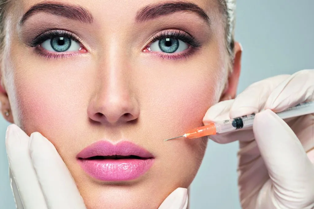 Woman receiving facial cosmetic injection in cheek Annapolis MD