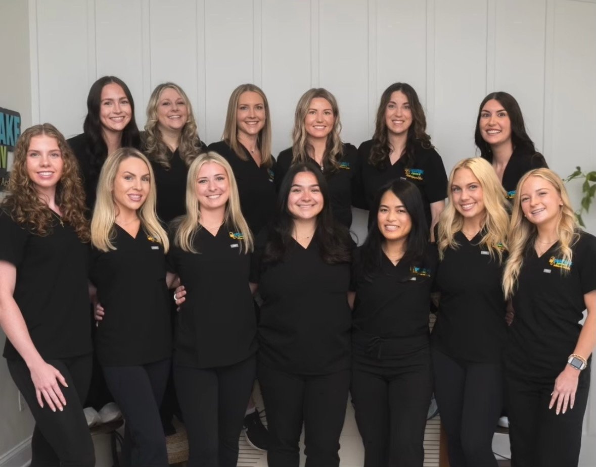 Smiling medical team in black scrubs indoors annapolis md