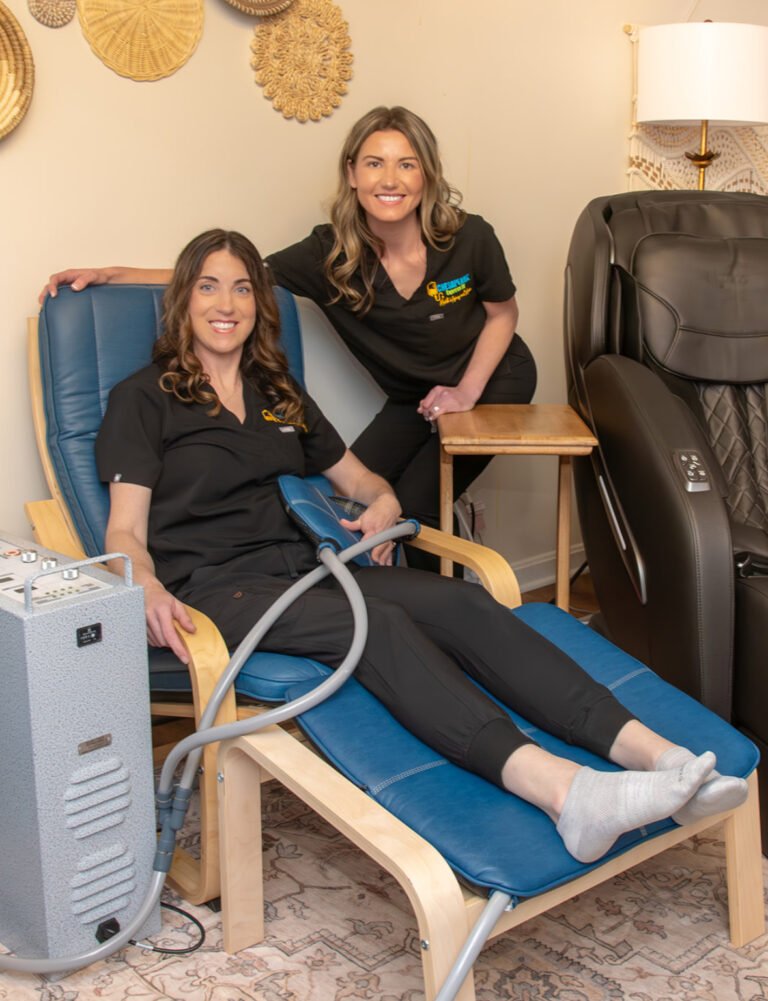 Two clinicians in wellness clinic with therapy device