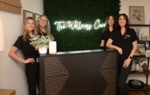 Four staff at wellness clinic reception desk